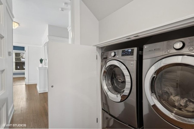 laundry area featuring dark hardwood / wood-style flooring and washing machine and dryer