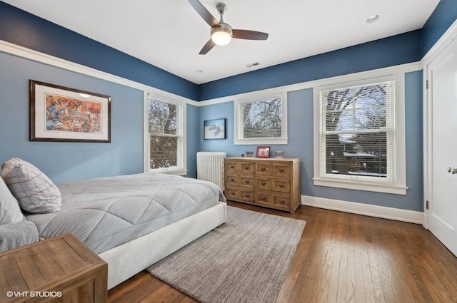 bedroom featuring dark hardwood / wood-style flooring and ceiling fan