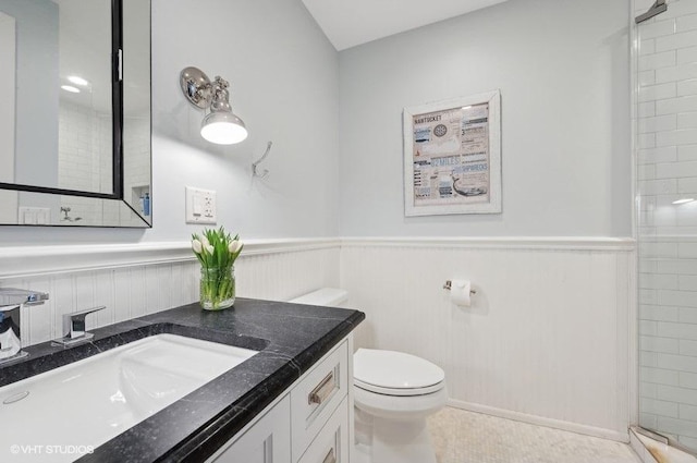 bathroom featuring vanity, tiled shower, tile patterned floors, and toilet