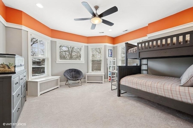 carpeted bedroom featuring ceiling fan and radiator heating unit