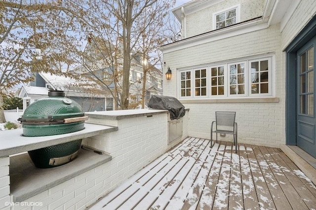 snow covered deck with area for grilling