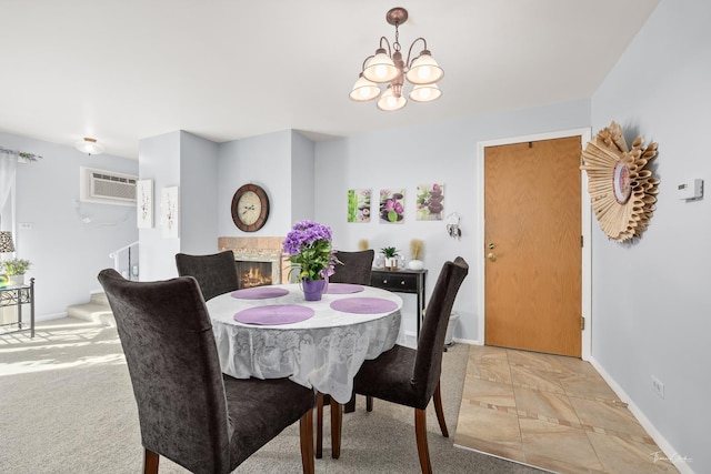 carpeted dining room featuring a brick fireplace, a wall mounted air conditioner, and a notable chandelier