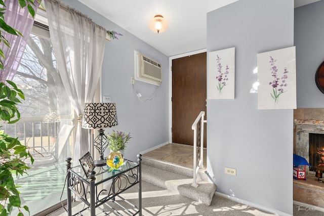 entryway with carpet flooring and a wall unit AC