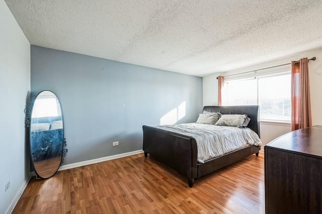 bedroom featuring wood-type flooring and a textured ceiling