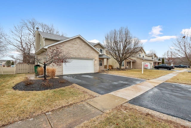 view of front of home featuring a garage and a front lawn