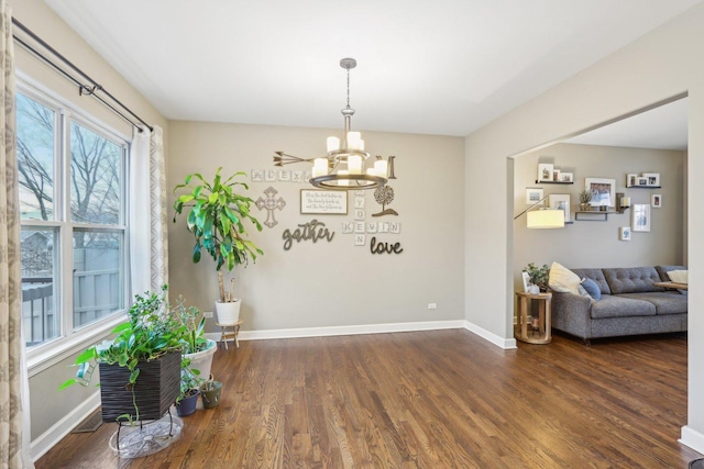 interior space featuring a notable chandelier and dark wood-type flooring