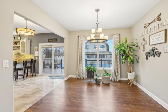 dining area with a notable chandelier and wood-type flooring