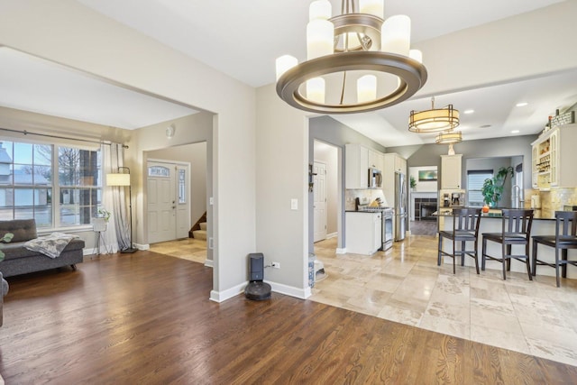 interior space featuring an inviting chandelier and light hardwood / wood-style floors