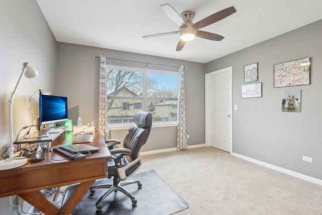 carpeted office space with ceiling fan