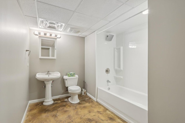 bathroom featuring bathing tub / shower combination, a paneled ceiling, concrete floors, and toilet