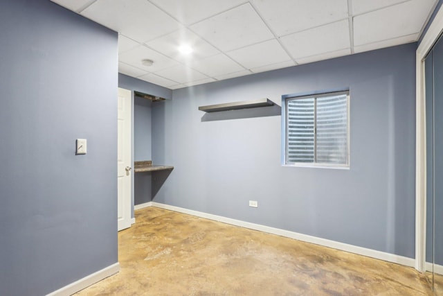 basement with a paneled ceiling