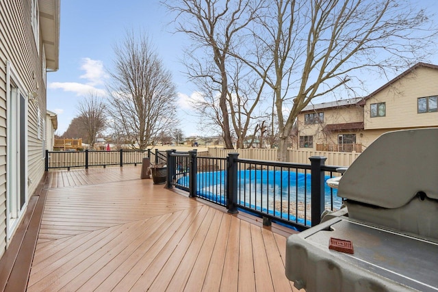 deck featuring a covered pool