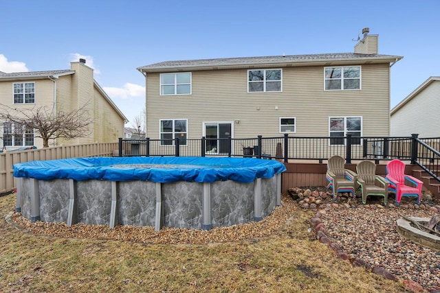 back of house with a covered pool