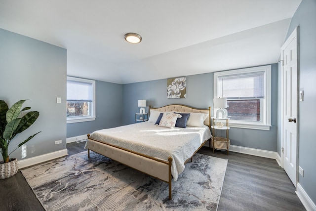 bedroom featuring lofted ceiling and multiple windows