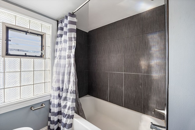 bathroom featuring shower / tub combo with curtain and toilet