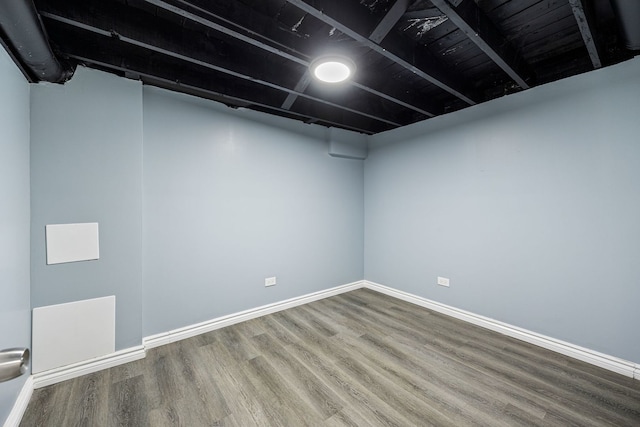 unfurnished room with wood-type flooring