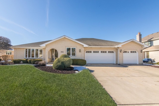 single story home featuring a garage and a front yard