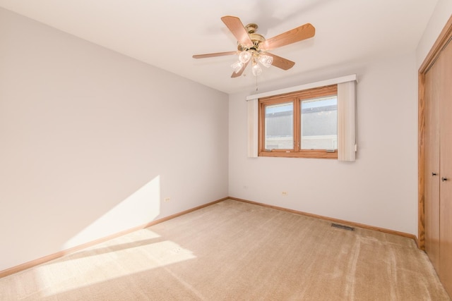 unfurnished bedroom with light colored carpet, a closet, and ceiling fan