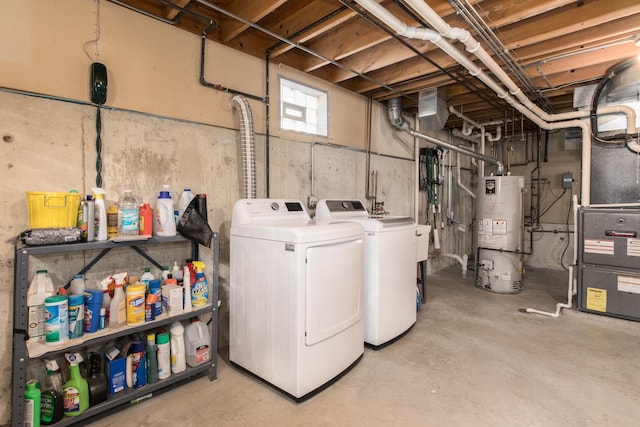 clothes washing area featuring washer and clothes dryer and water heater