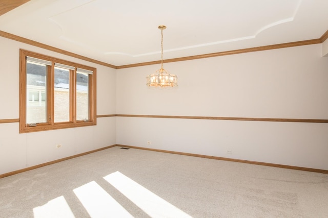 carpeted spare room with crown molding and a notable chandelier