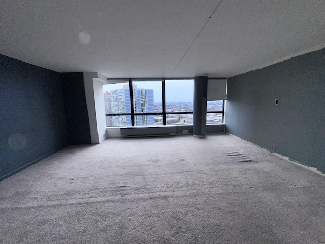 carpeted empty room featuring a textured ceiling