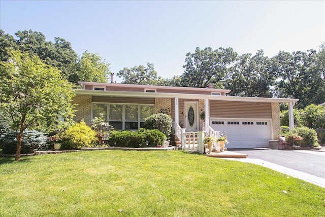 view of front of house with a garage and a front lawn