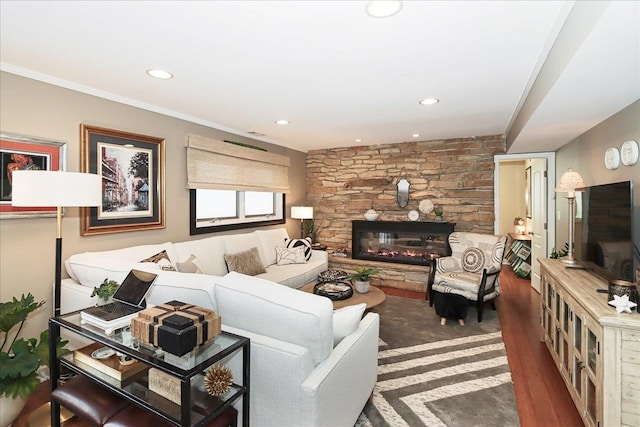 living room featuring dark hardwood / wood-style flooring, ornamental molding, and a fireplace