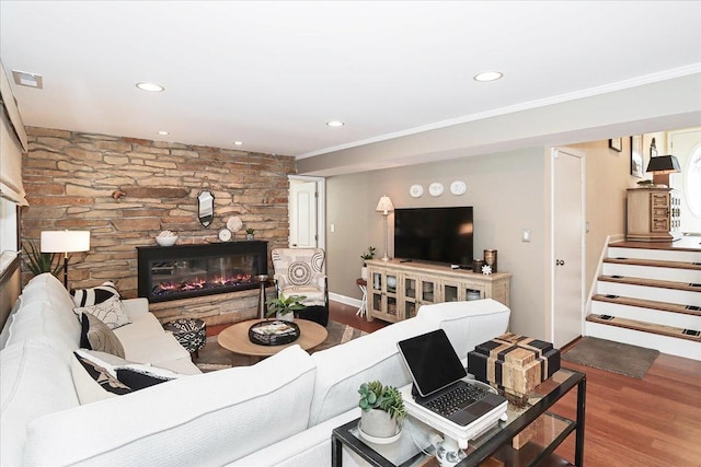 living room with ornamental molding, hardwood / wood-style floors, and a fireplace