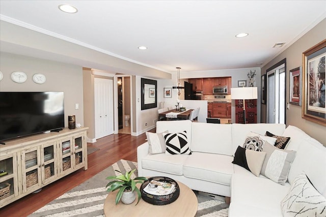 living room featuring ornamental molding and dark hardwood / wood-style flooring