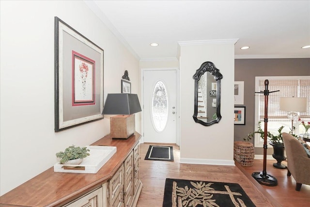 foyer entrance featuring ornamental molding and light hardwood / wood-style flooring