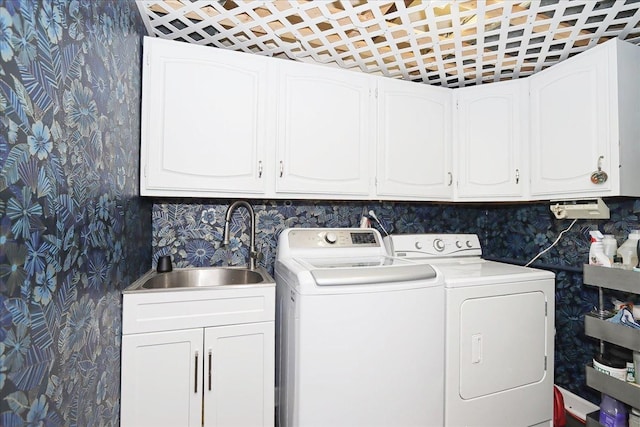 laundry area featuring cabinets, sink, and washing machine and clothes dryer