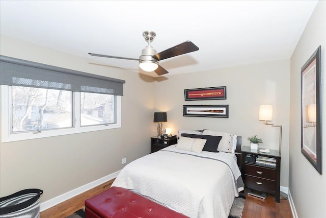 bedroom with dark hardwood / wood-style floors and ceiling fan