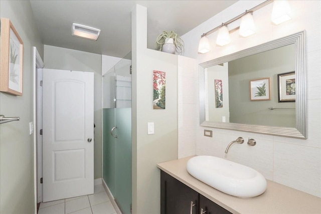 bathroom featuring tile patterned flooring, vanity, an enclosed shower, and decorative backsplash