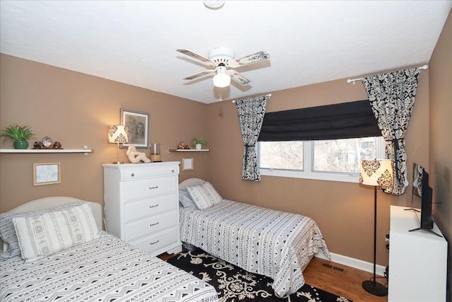 bedroom with ceiling fan and wood-type flooring