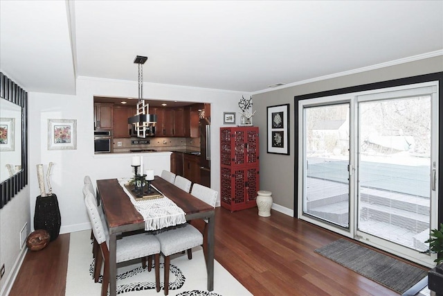 dining space featuring dark hardwood / wood-style flooring and ornamental molding