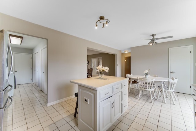 12850 S Westport Dr, Palos Park, IL 60464 - kitchen featuring light tile patterned flooring, white cabinetry, stainless steel fridge, a center island, and ceiling fan