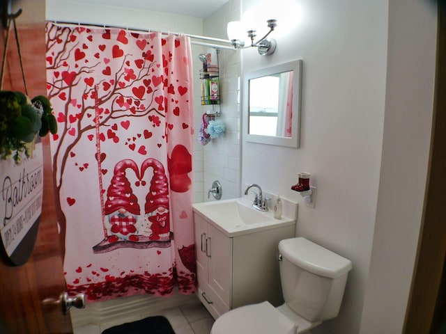 bathroom featuring tile patterned flooring, vanity, and toilet