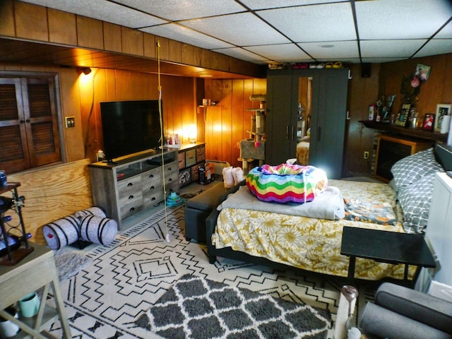 bedroom featuring wooden walls