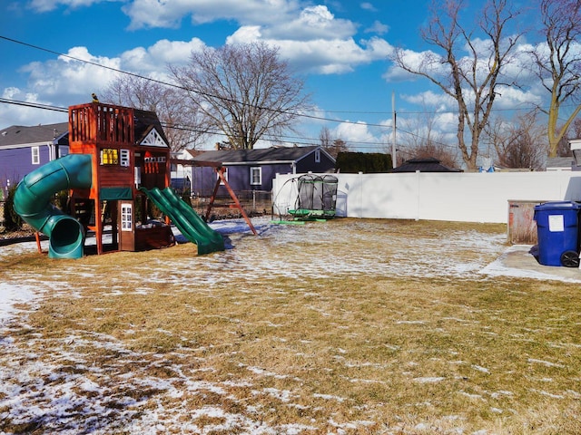 snow covered playground featuring a yard