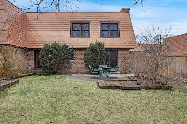 rear view of house with a yard and a patio area