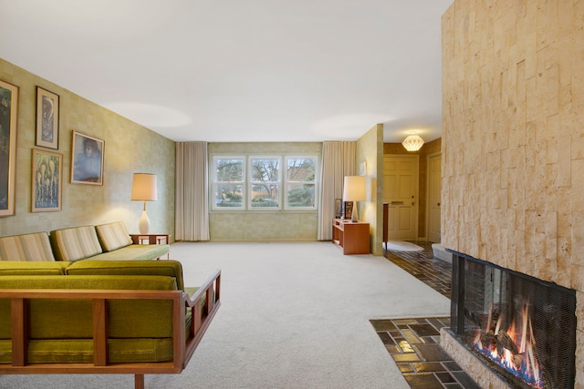 carpeted living room with a multi sided fireplace