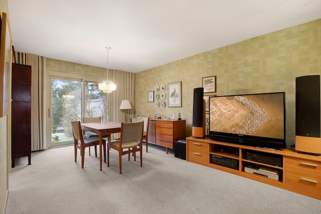 dining room with light colored carpet and a notable chandelier