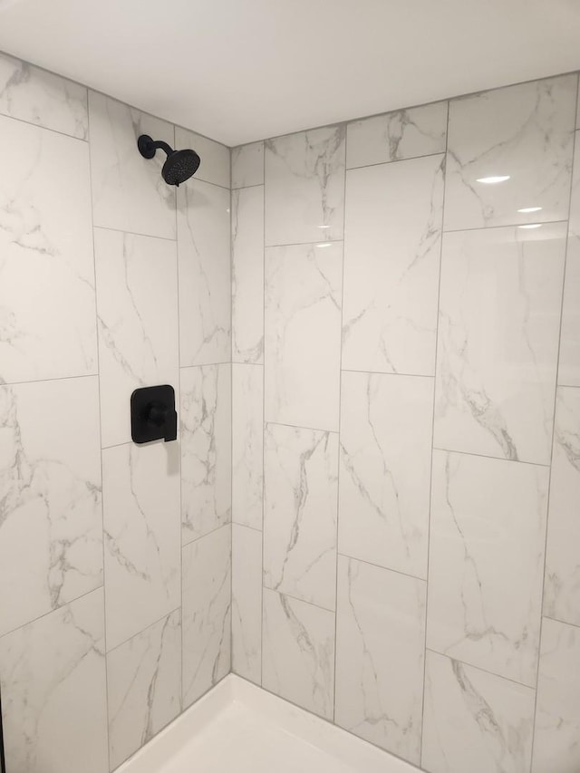 bathroom with a tile shower