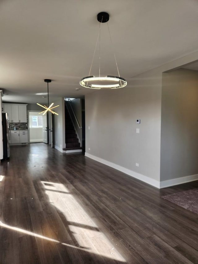 unfurnished living room featuring dark hardwood / wood-style floors