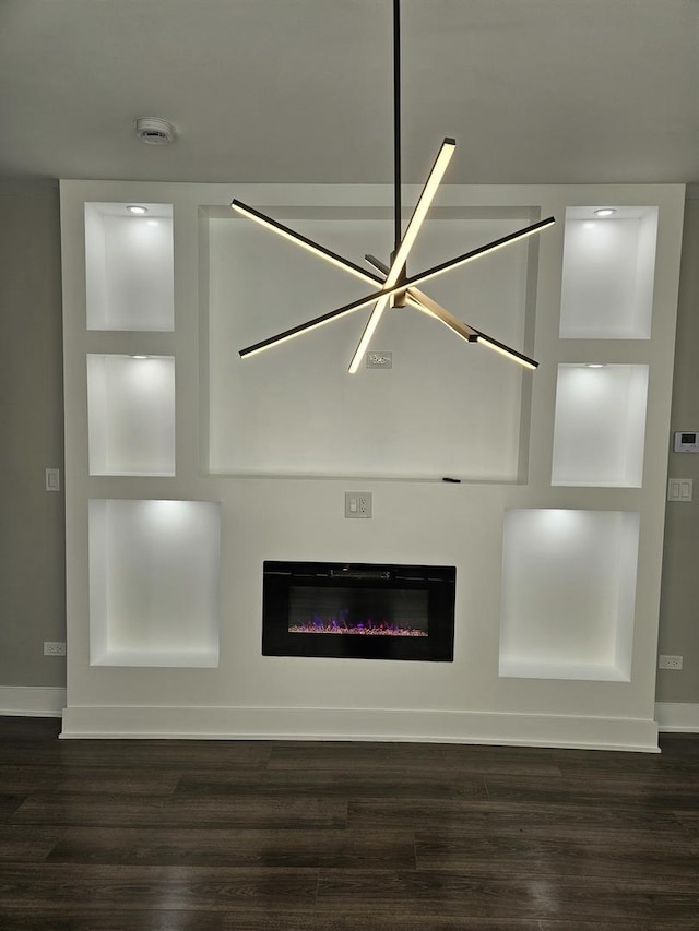 interior details with wood-type flooring and a chandelier