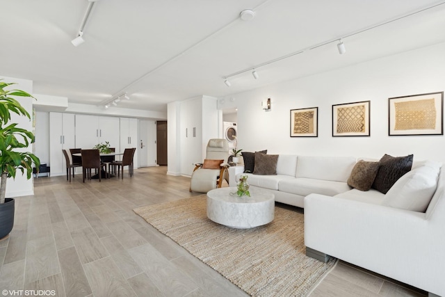 living room featuring track lighting and light hardwood / wood-style floors