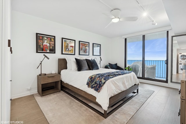 bedroom featuring ceiling fan, track lighting, access to exterior, and light wood-type flooring