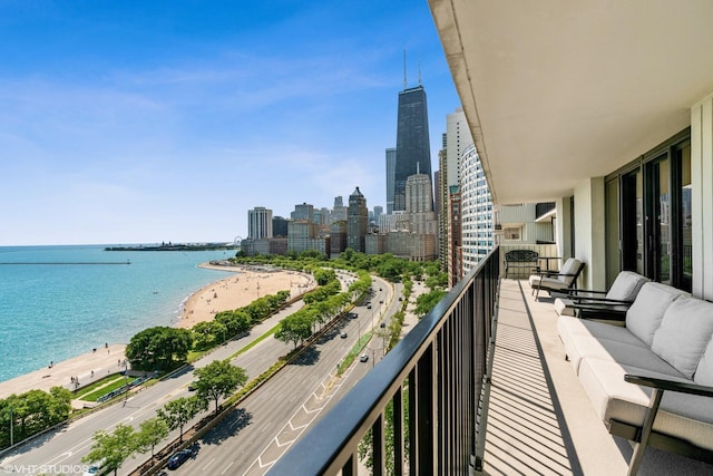 balcony with a water view and a beach view