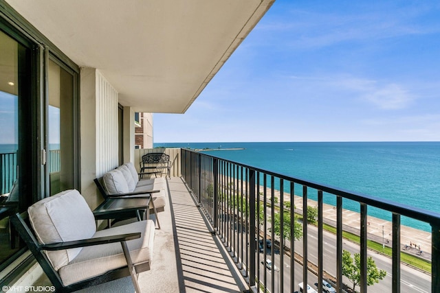 balcony with a water view and a beach view