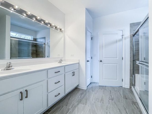 bathroom with a shower with door and vanity